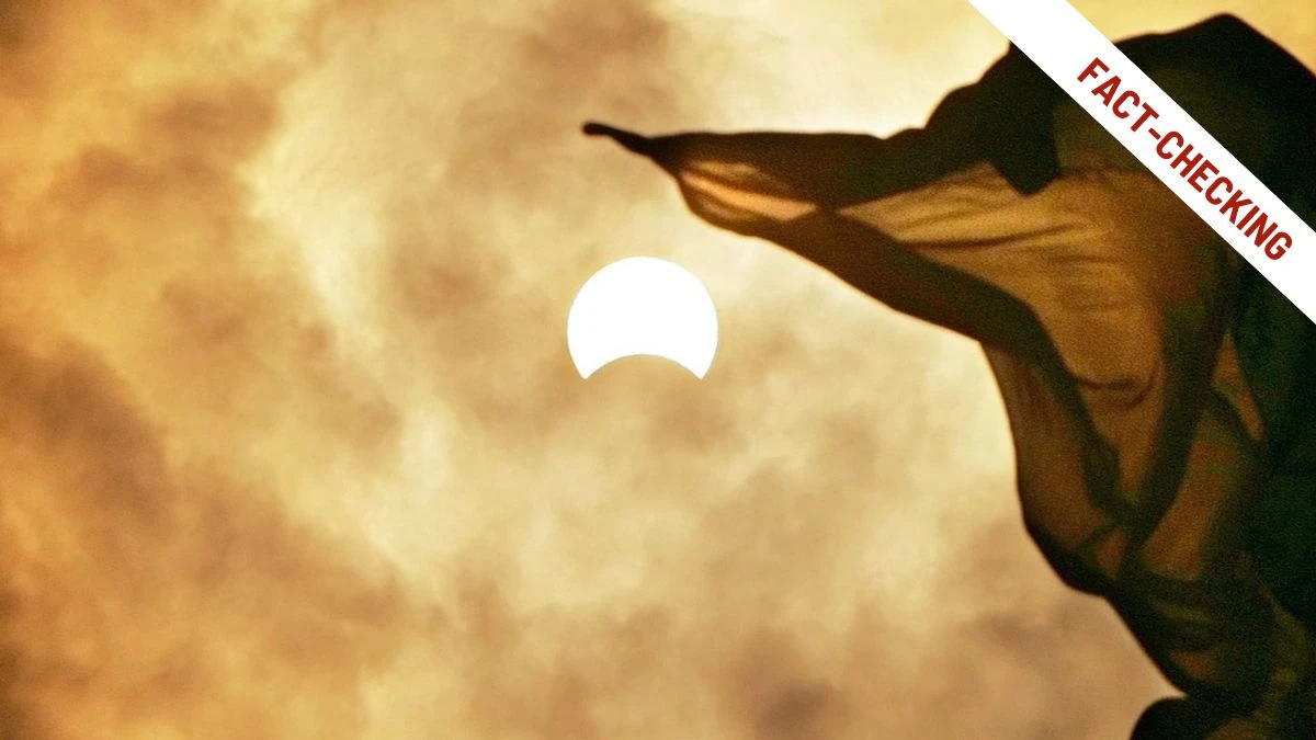 Eclissi solare parziale fotografata su un cielo dai toni caldi